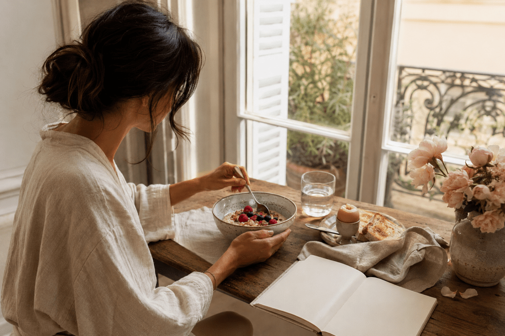 Woman enjoying a nourishing breakfast as part of a calm morning routine.